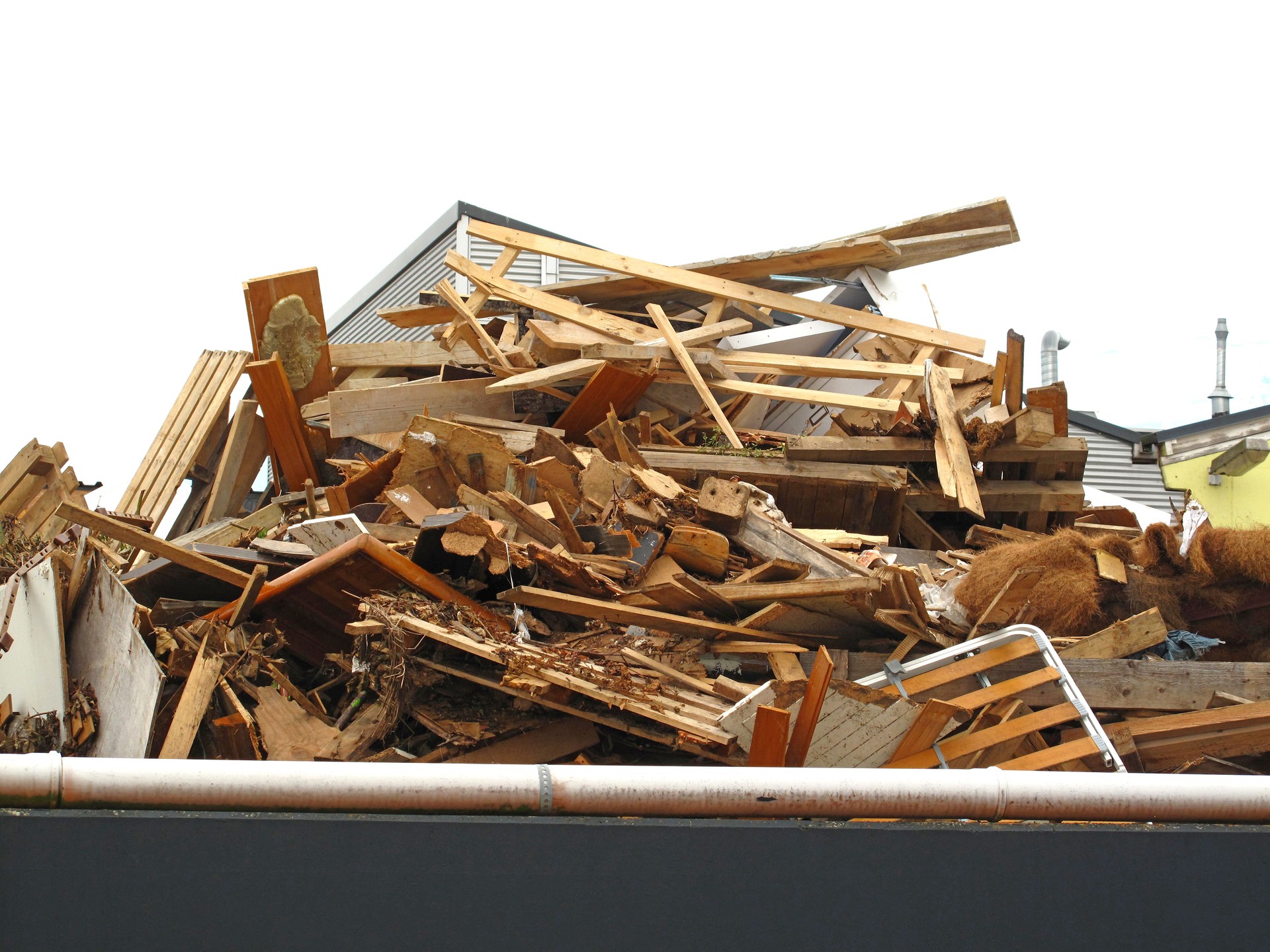 Debris and wooden remains and garbage pile on a stack on demolition site of a building