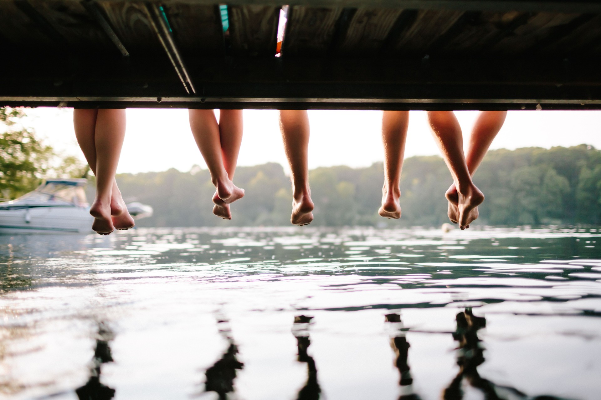Two Couples Sitting On A Jetty